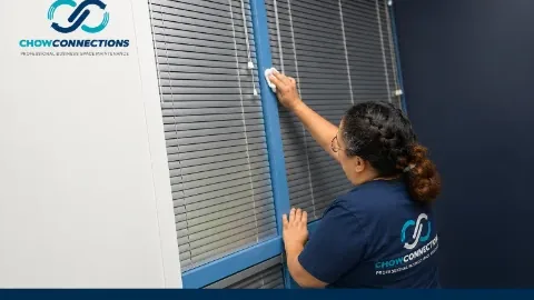 Chow Connections crew member cleaning windows at an Indianapolis business