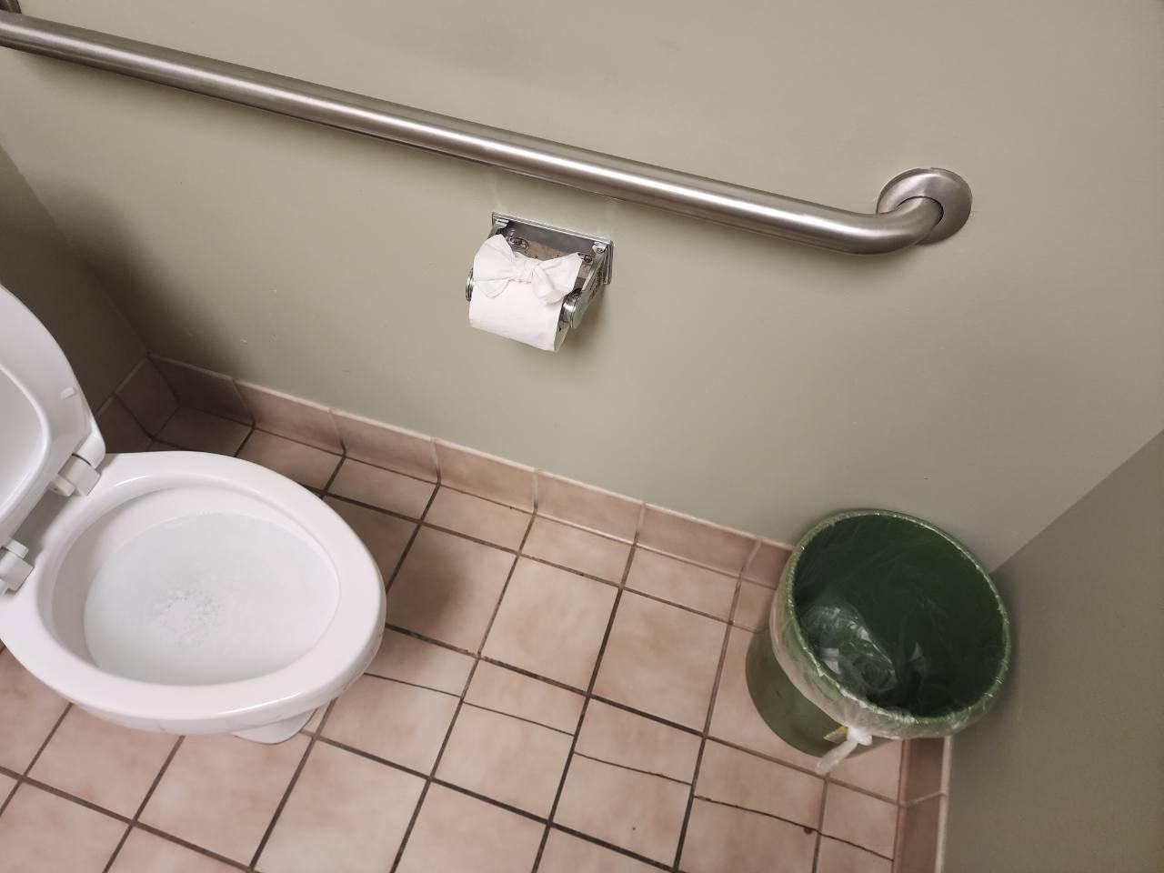 Restroom stall after cleaning and restocking