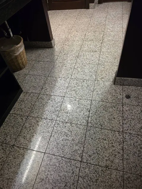 Restroom floor in an Indianapolis commercial facility after cleaning: tile floor swept and mopped