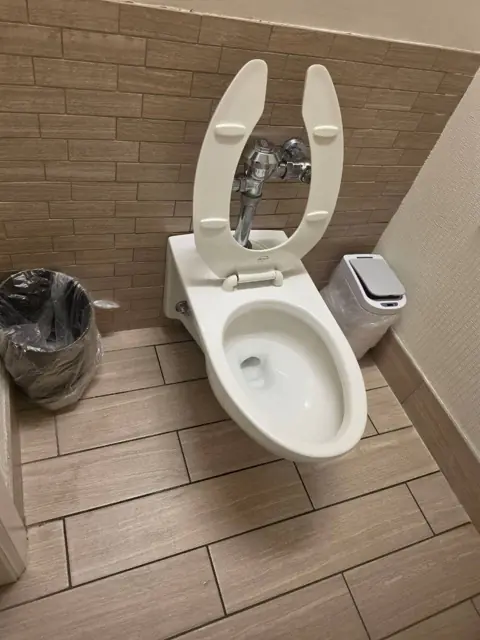 Restroom stall in an Indianapolis commercial facility after cleaning: toilet, flush valve and floor cleaned